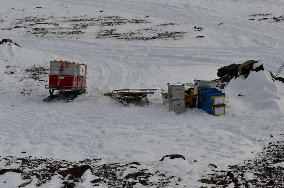 Equipment boxes sitting in the snow.