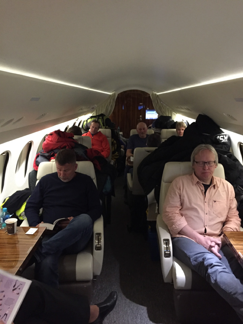 The team sitting in the Falcon jet.