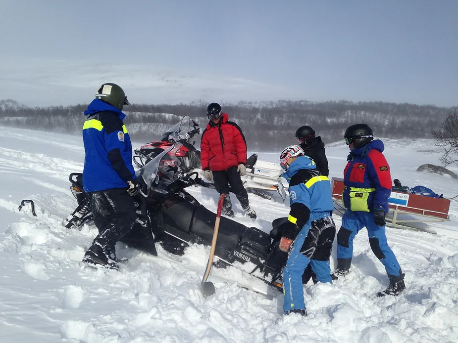 The team training with a snowmobile.