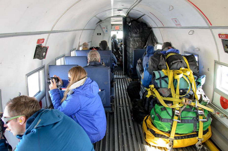 The team looking out the window of the plane.